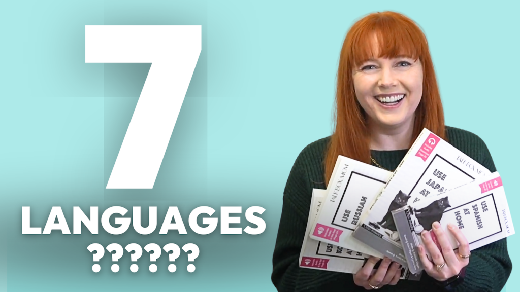 7 Languages? Adelaide holding phrasebooks for use Spanish at Home, Use Japanese at Home, and Use Russian at Home