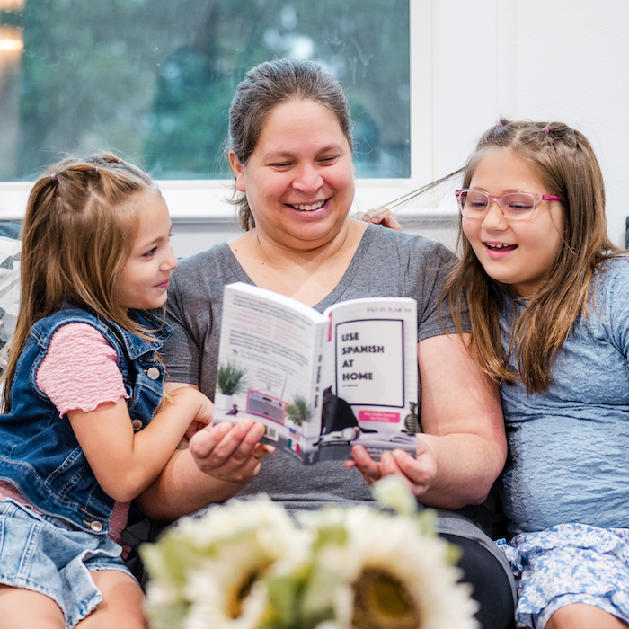Fluency family reading the Use Spanish at Home book